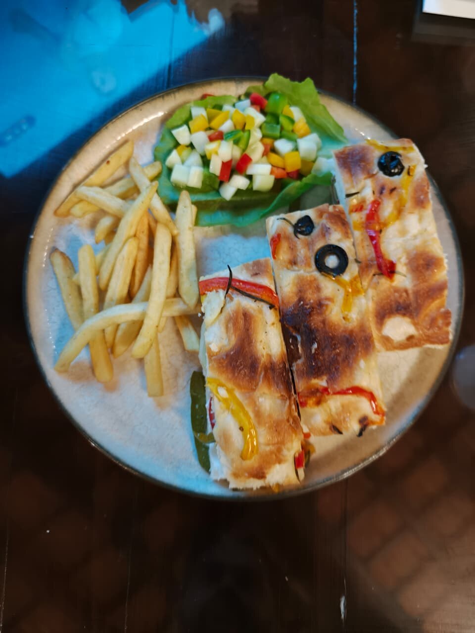 Plate with baked savoury bites, fries and salad on the Goa trip