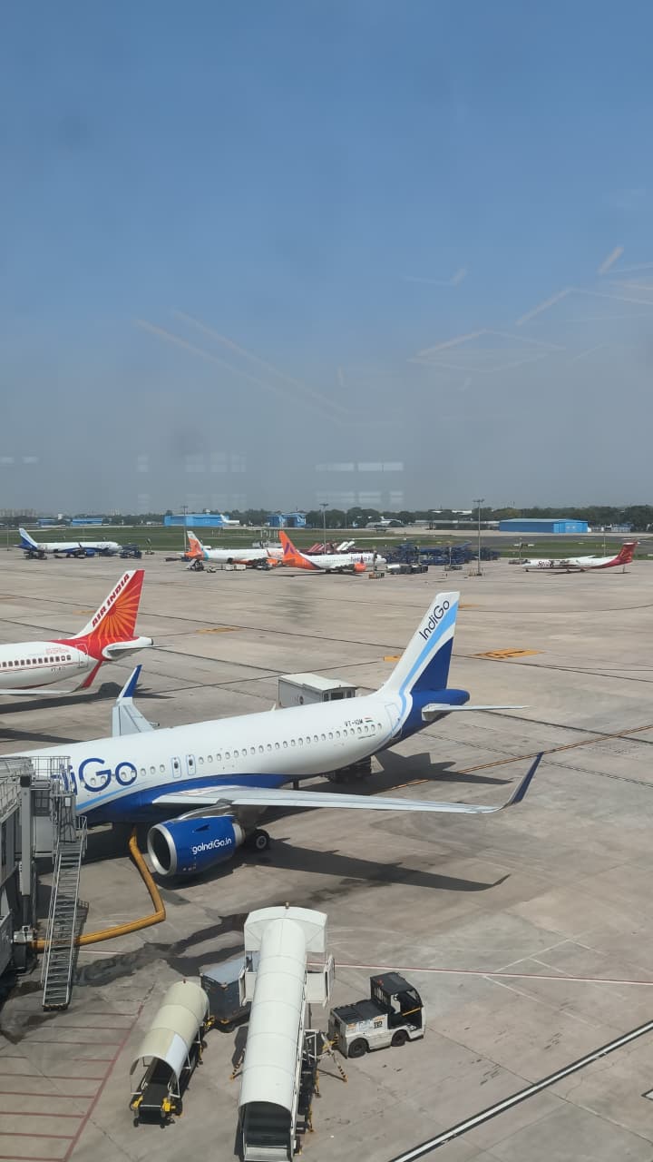 Airport apron with IndiGo and Air India aircraft